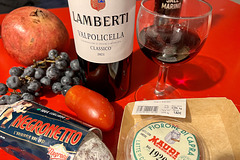 Venice 2022 – Still life with pomegranate, grapes, sausage, tomato, wine, cheese and salt