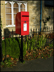 sunlight on a red post box