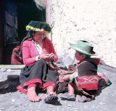 A smiling Pisac mother fixing her "ojotes"