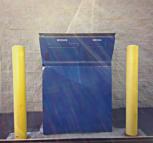 Blue box with yellow posts and fractured sunlight