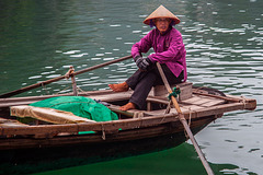 Fisher woman rows out selling souvenirs