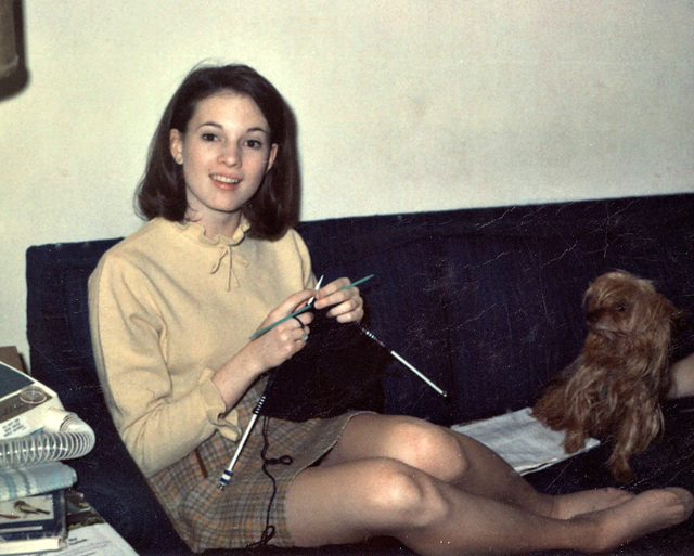 Young woman knitting with dog, 1968