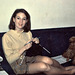 Young woman knitting with dog, 1968