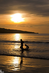 Water games at sunset of the beach Jimbaran, Bali