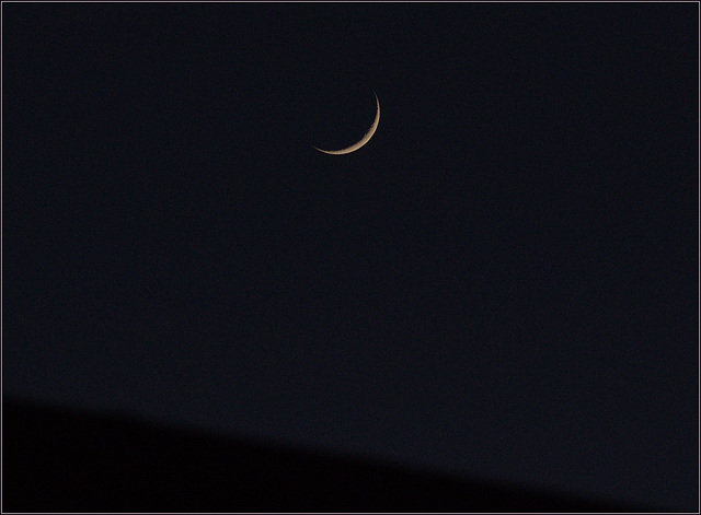 Newish moon over the neighbours' house