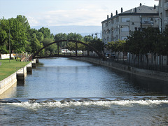 Weir and pedestrian bridge on River Tâmega.