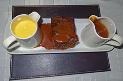 Sticky toffee pudding with a caramel sauce and custard