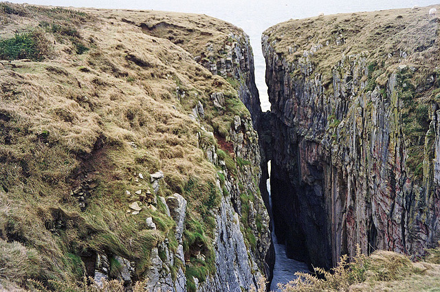 Huntsman's Leap seen from the Pembrokeshire Coast Path (Feb 1995 scan)