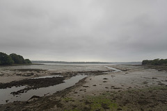 Landshipping Pill, Pembrokeshire, at low tide on a grey, sombre day.