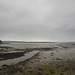 Landshipping Pill, Pembrokeshire, at low tide on a grey, sombre day.