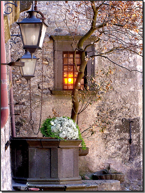 Bracciano : Castello Odescalchi - nel cortile interno : il pozzo, la fontana, l'alberello, i lampioni, la finestra illuminata