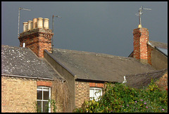 rooftops in a stormy sky