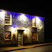 The illuminated wall of 'The Plough'.