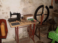 Old sewing machine and spinning wheel.