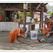 Monks build a plug on a submersible pump in Ban Xang Hai