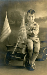 Boy with Roller-Bearing Wagon and Fluttering Flags