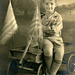 Boy with Roller-Bearing Wagon and Fluttering Flags