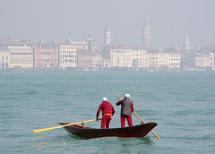 Two elderly boatmen rowing across to Dorsoduro