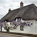 Wisteria covered houses in Okeford Fitzpaine.