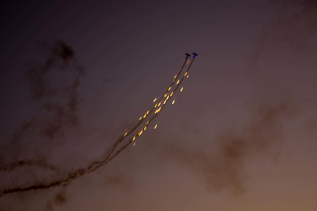 Blue glowing planes dropping flares..