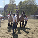 Beautiful draft horses accompanied by handsome men galloping