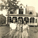 Three women stand before a DISTINCTIVE HOUSE in the Vintage Photos Theme Park