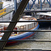 Barge with men behind bridge