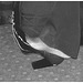 Black Lady in black & red hammer heels / Noire sexy en beaux souliers à talons hauts rouge & noir - Avec permission / With permission - Aéroport de Bruxelles / Noir et blanc avec photofiltre.