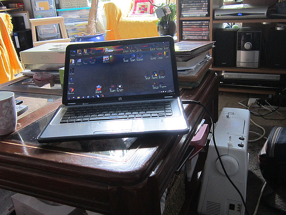 My laptop on the coffee table & my sewing machine