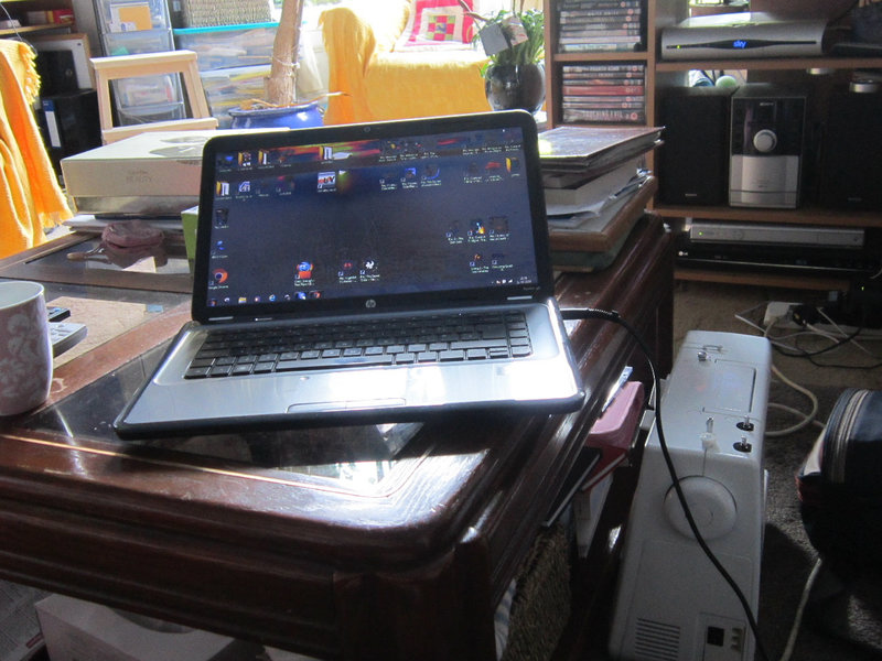 My laptop on the coffee table & my sewing machine