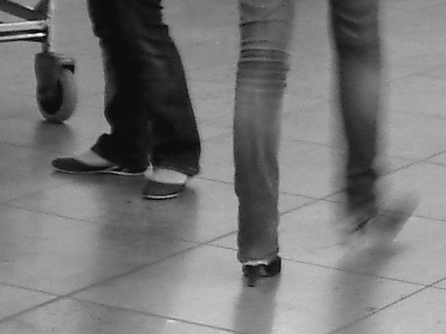 Short & cute Lady on flats & booted blond in jeans-  Brussels airport -19-10-2008- B & W