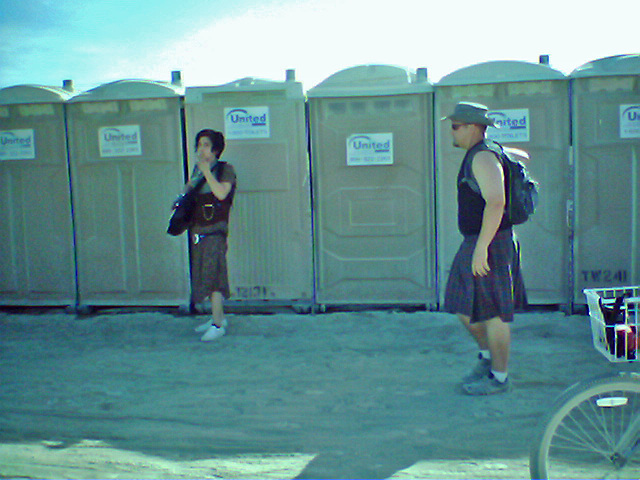 Gay Pride Parade Passes Man With Guitar Behind Porta-Potties (0011)