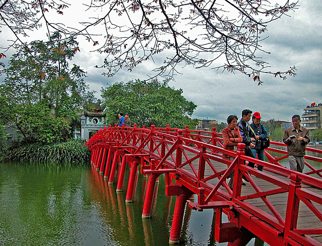 Crossing the Huc Bridge over the Hoàn Kiếm Lake