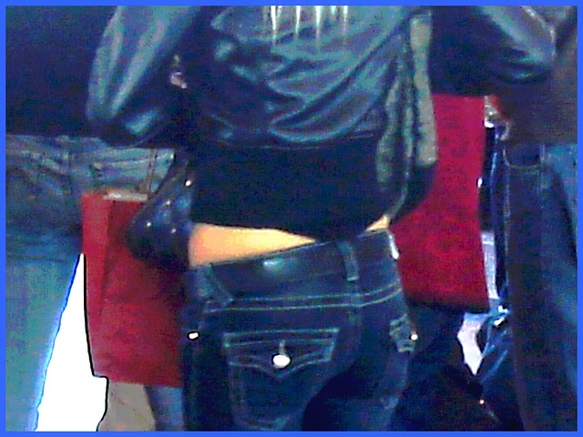 Young sexy blond in Bossy Boots with a gorgeous bum in jeans- PET Montreal airport- Photofiltrée en bleu.