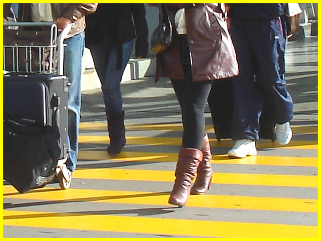 High heeled Boots and tights on yellow lines -  Bottes à talons hauts et collants sur lignes jaunes- Aéroport de Montréal.