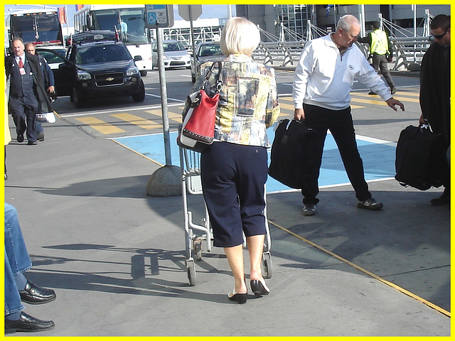 Blond mature in white sexy strappy sandals-  Dame blonde du bel âge en sandales blanches à courroies -  Aéroport de Montréal.