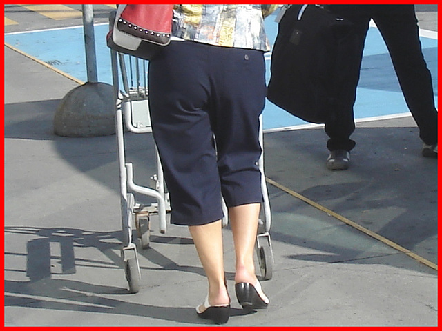 Blond mature in white sexy strappy sandals-  Dame blonde du bel âge en sandales blanches à courroies -  Aéroport de Montréal.