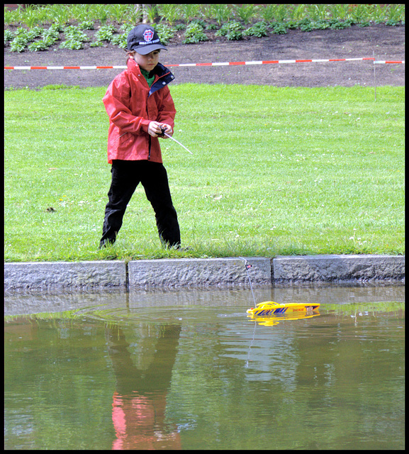 Boy with radio-controlled boat