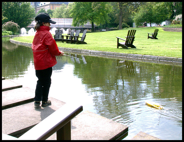 Boy with radio-controlled boat