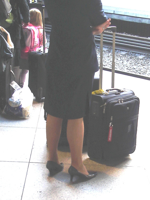 Blond flight attendant smoker in high heels shoes - Copenhagen train station airport  /  October 20th 2008