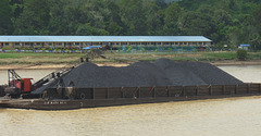 Coal Barge Passing Modern Longhouse