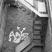 Escaliers de secours et graffiti sur mur de briques /  Fire escape and bricks wall hometown graffiti  / B & W