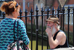 Mark Golding, artist, on Lewes High Street on a summer Saturday afternoon chatting with a passer-by