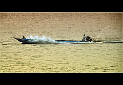 two man in a fast boat