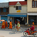 Monks walk along the Chao Siphouphan