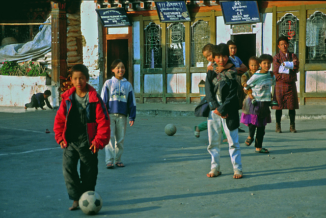 Children playing soccer in Mongar