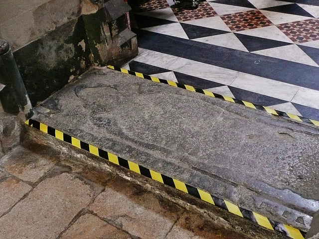ely cathedral, c13 tomb,matrix of brass with lombardic lettering, probably that dropped down to this position when the tomb chest here was cut through to allow side access to the choir. tomb of bishop