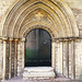 peterborough cathedral ;the doorway to peterborough's refectory to the south of the cloister is very ornate, with dragons in the stiffleaf of its tympanum. it dates from the early mid c13.