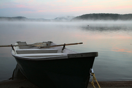 Silently the morning mist is lying on the water