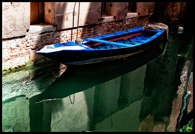 blue boat in green water